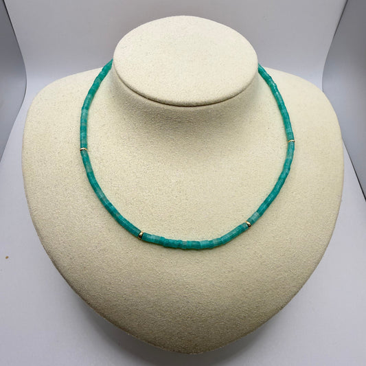 Bright blue beaded necklace on a white display bust
