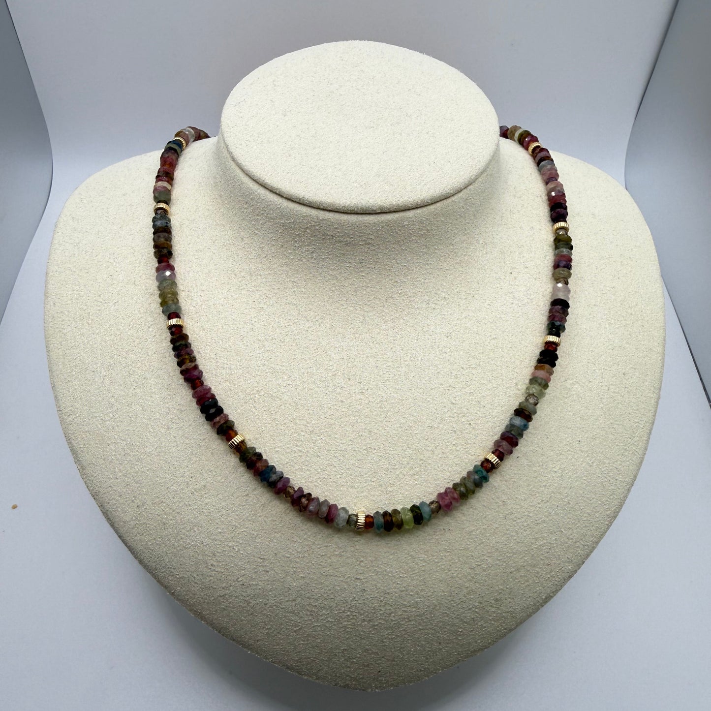 Necklace with multicolored beads on a white display bust